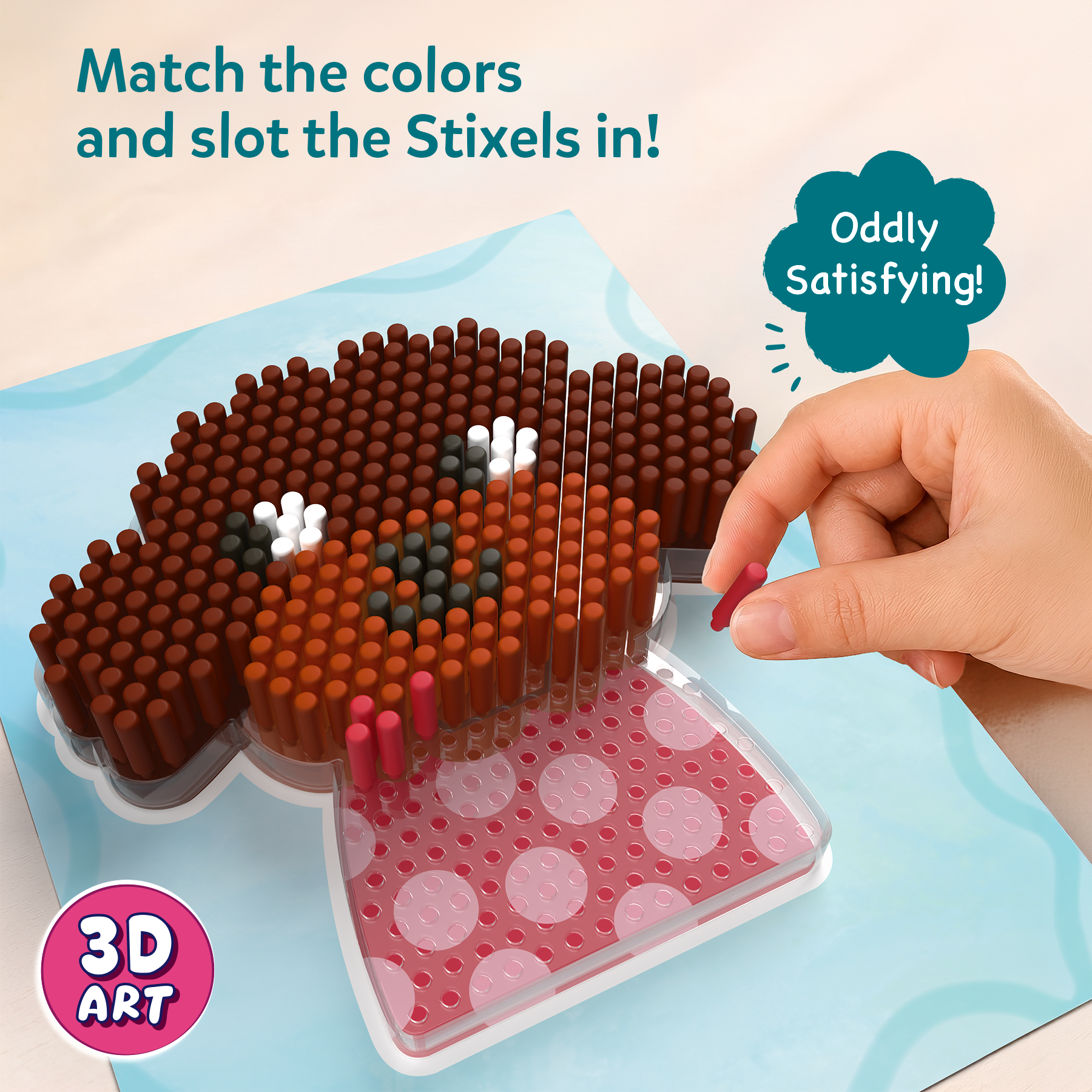 3D art creation with Stixels on a blue mat, hand placing a Stixel, text 'Match the colors and slot the Stixels in!'.