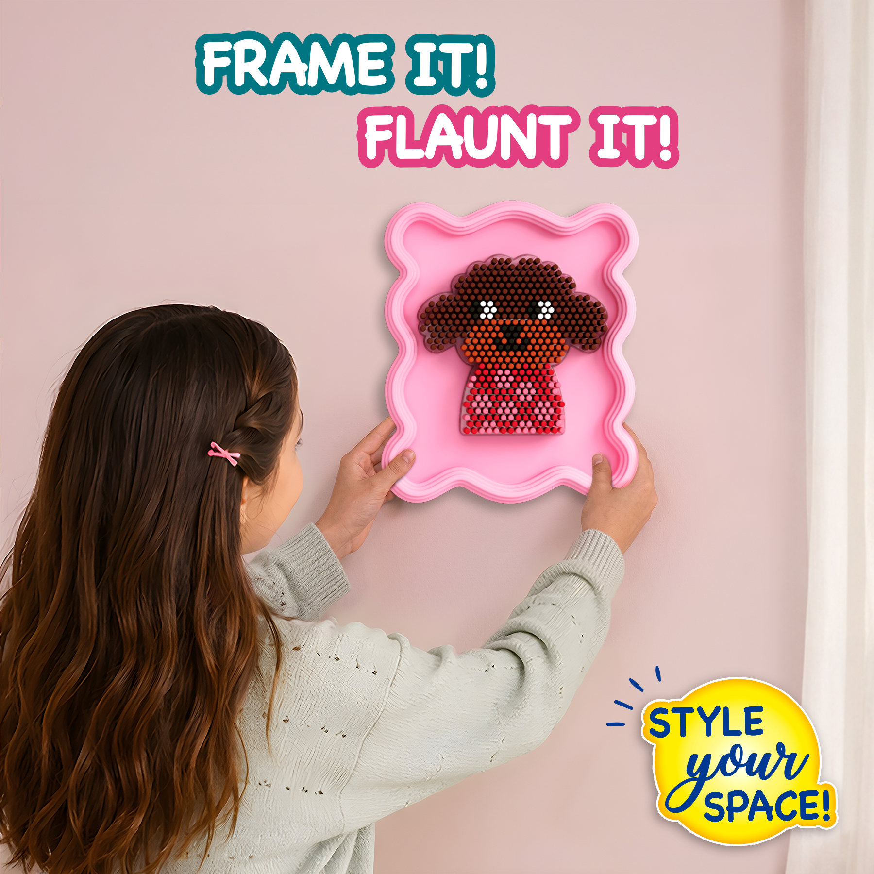 Person hanging a pink frame with a dog design on a wall, with text encouraging to 'Frame It! Flaunt It! Style Your Space!'
