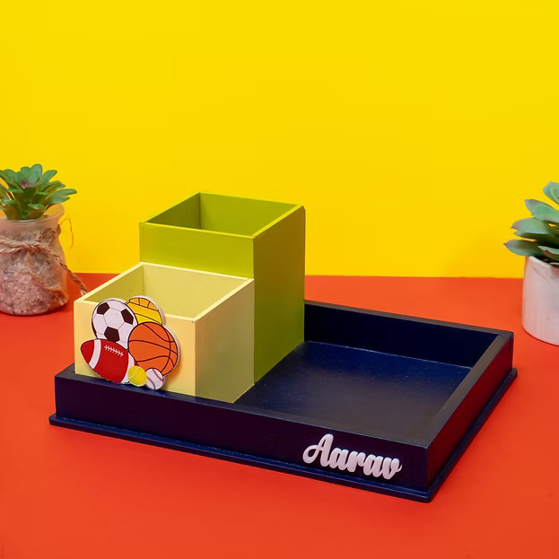 Desk organizer with sports-themed items on a red and yellow background