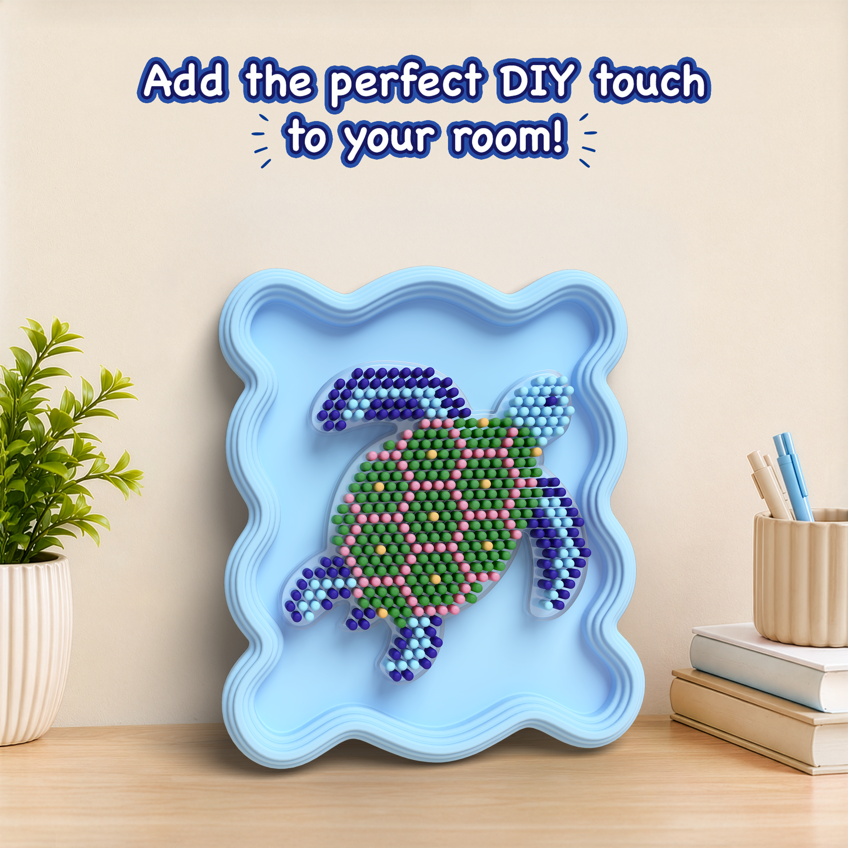 Decorative wall art with a turtle design on a blue frame, placed on a wooden surface with a plant and books in the background.