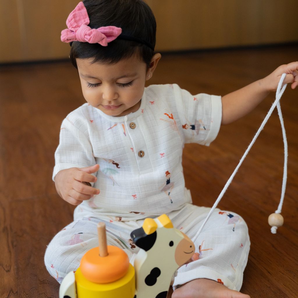Child playing with toys on a wooden floor
