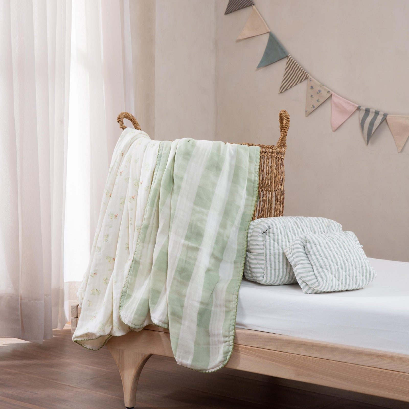 Bedroom with a wooden bed, green striped blanket, and decorative flags on a beige wall.