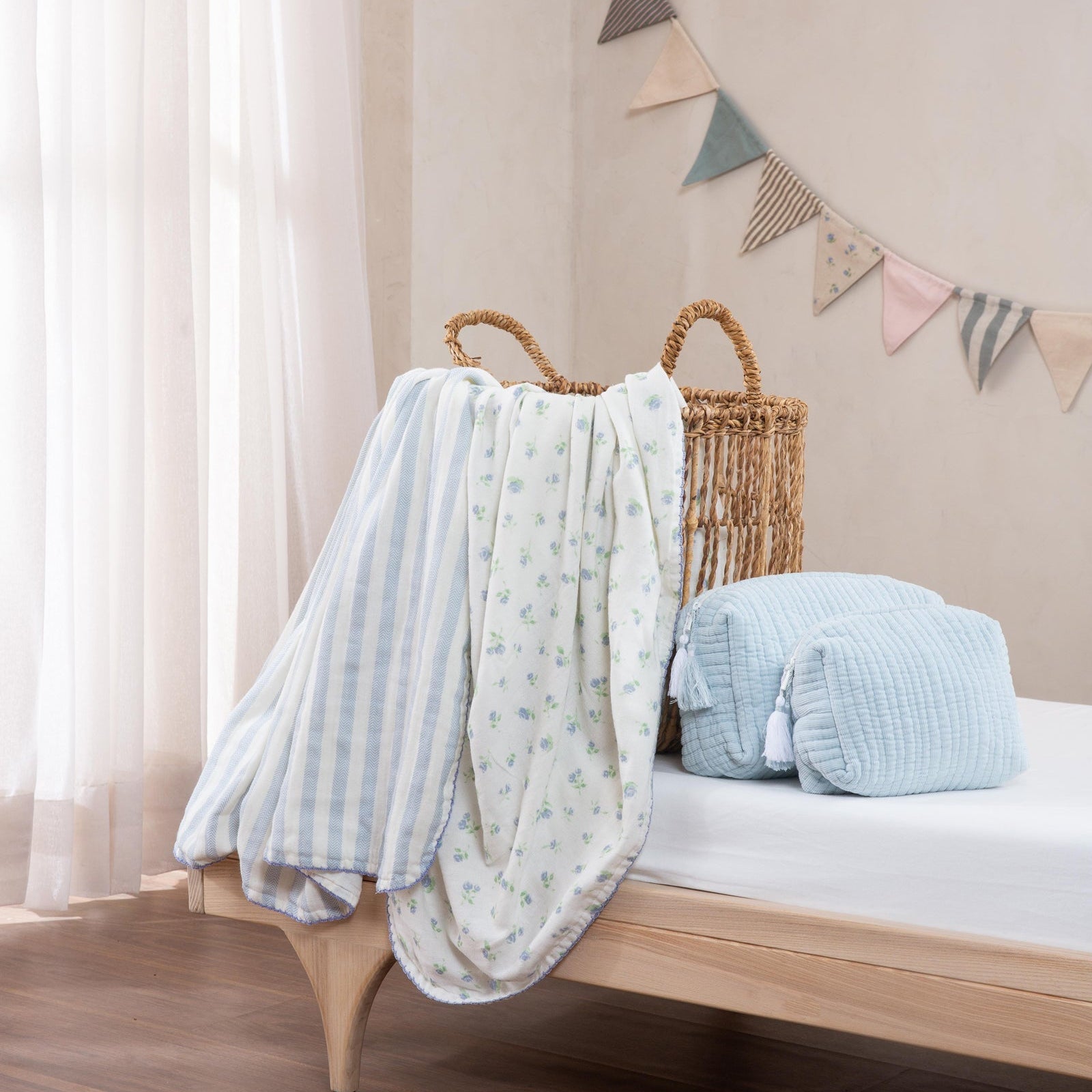 Bed with baby blankets and a pillow in a nursery setting