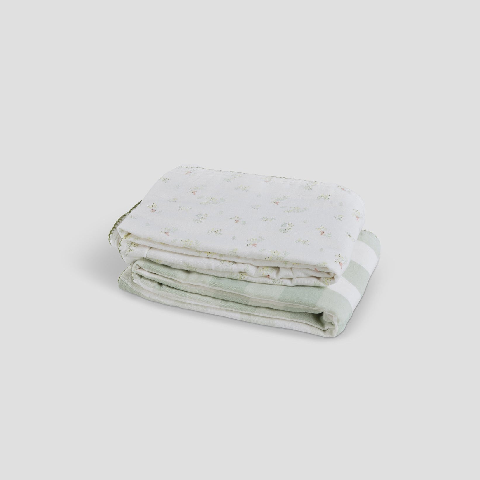 Folded fabric with a subtle pattern on a light gray background