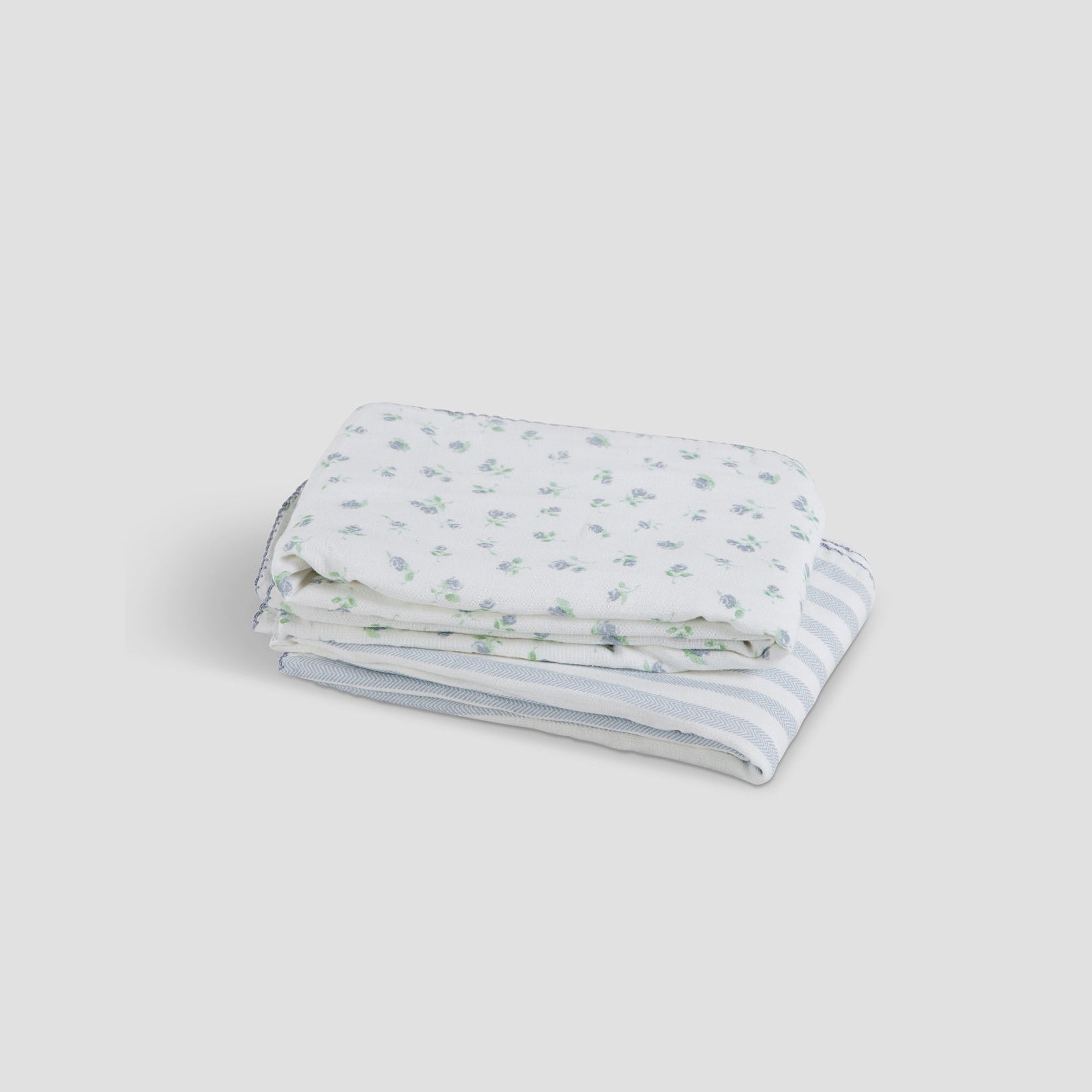 Folded fabric with blue and white pattern on a light gray background