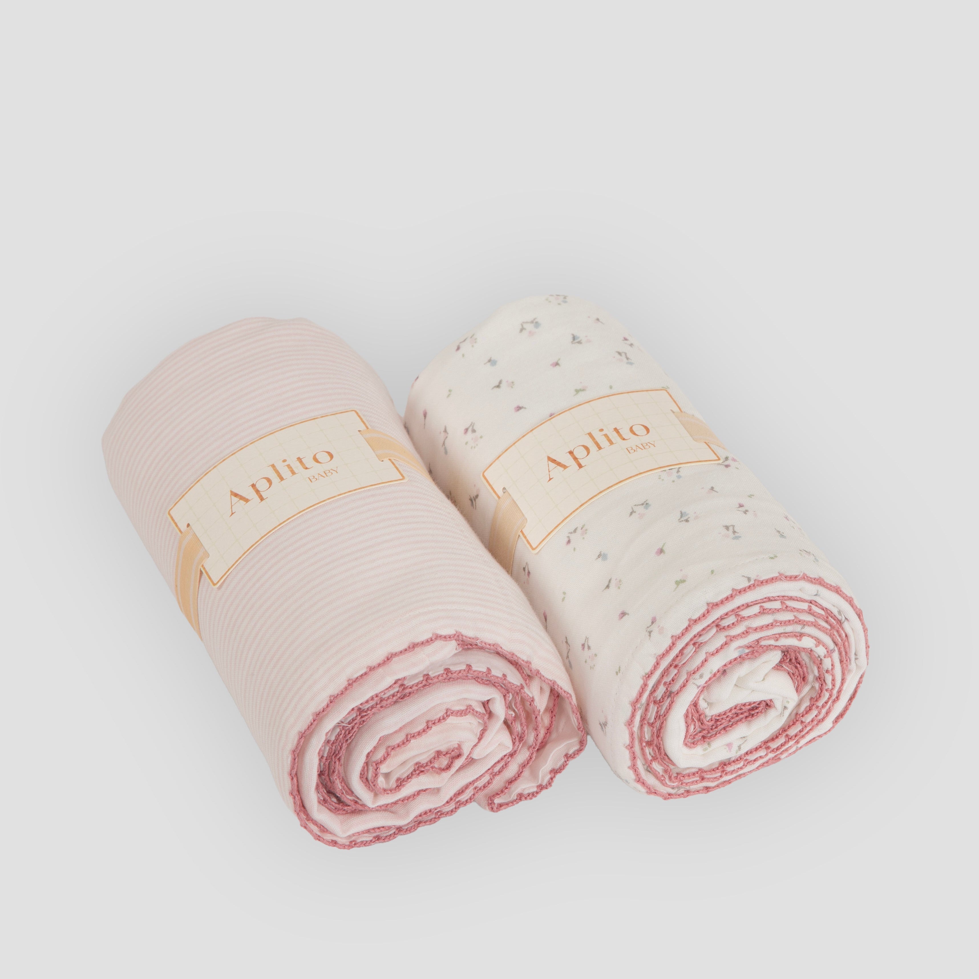 Two rolled-up towels with 'Aplilo' branding on a light gray background