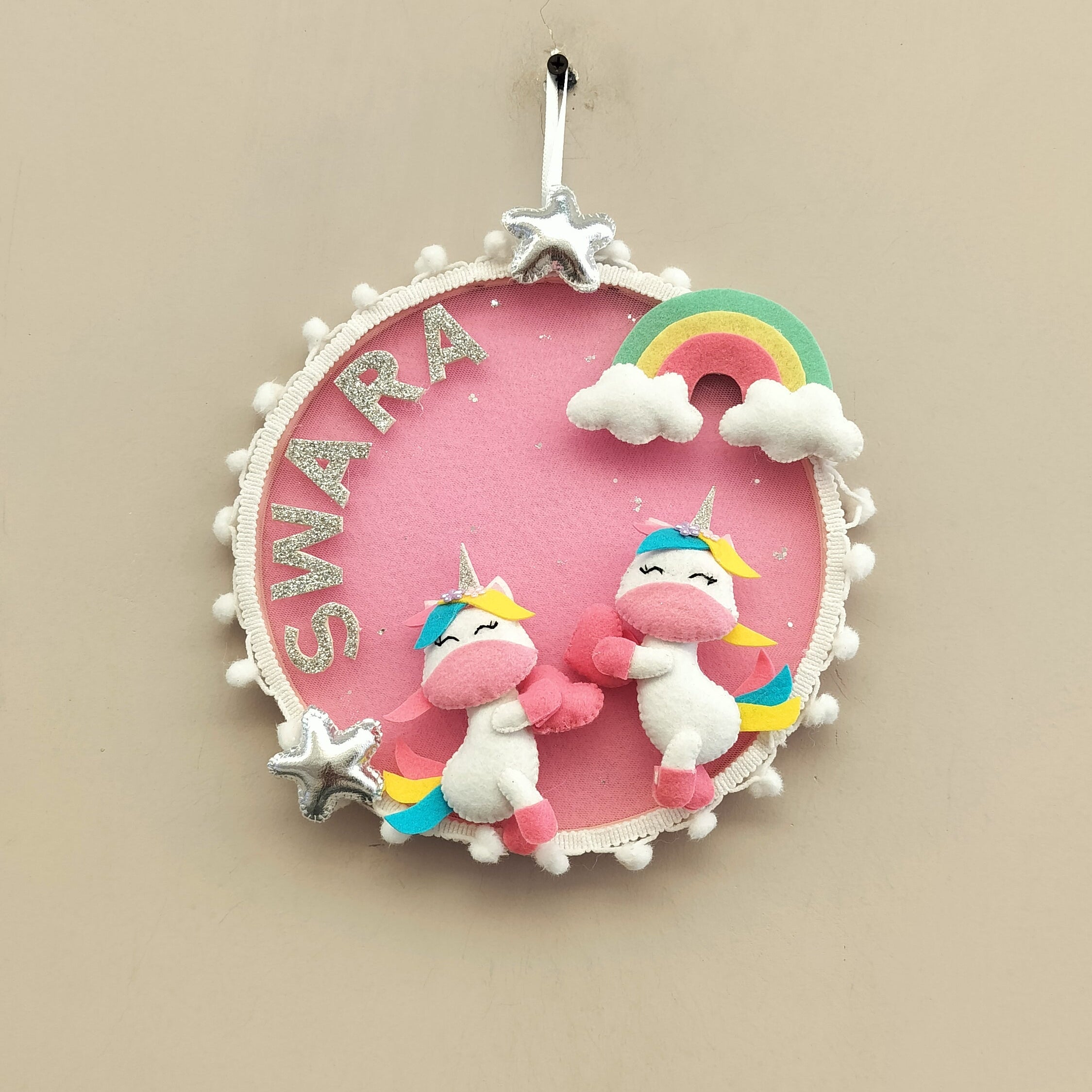 Unicorn-themed pendant with 'SWARA' branding on a beige background