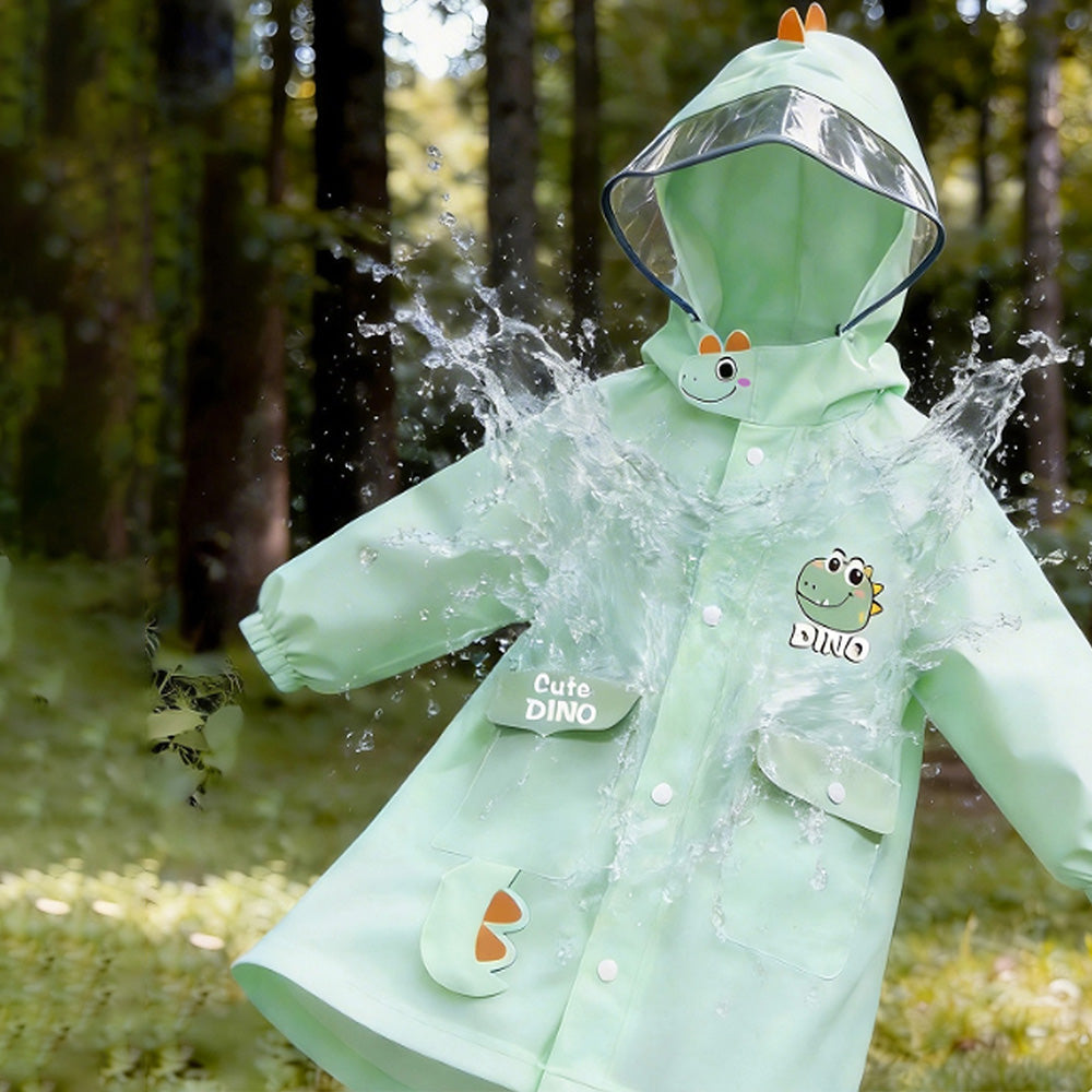 Child wearing a green raincoat with dinosaur designs in a forest setting