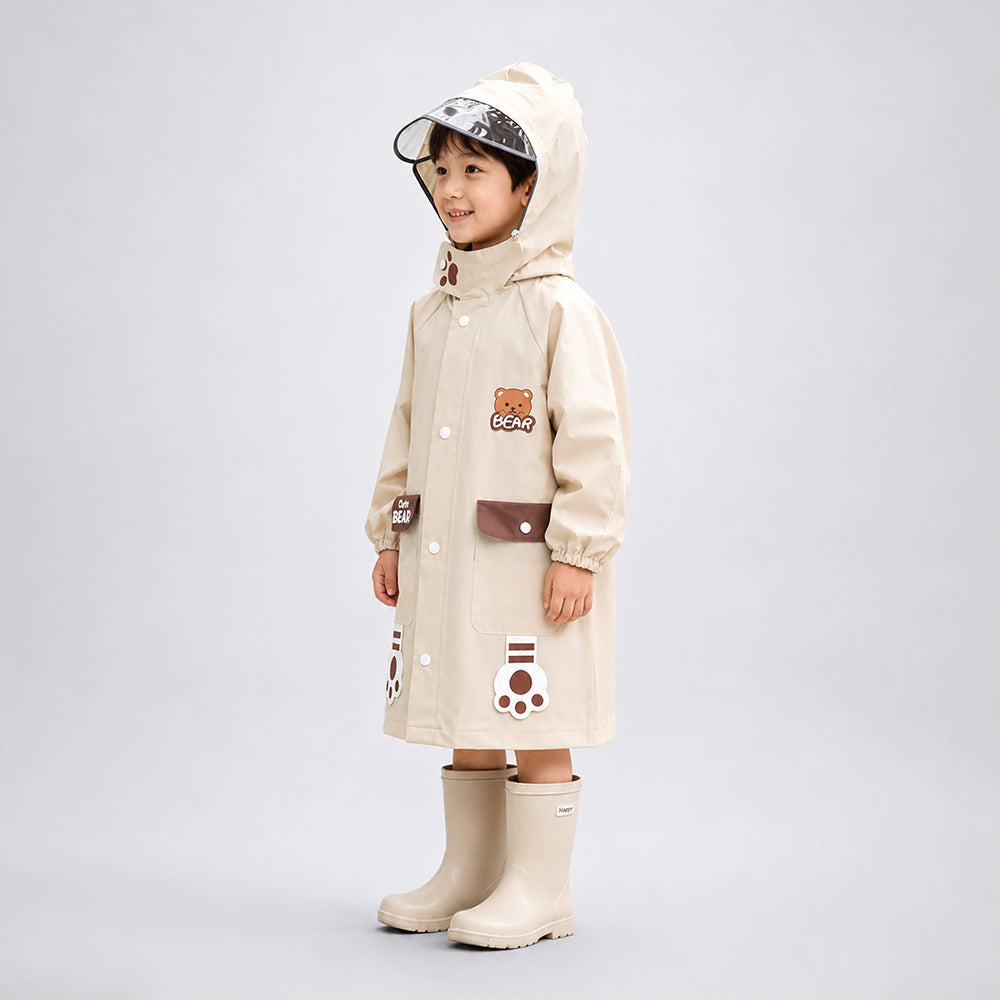 Child wearing a beige raincoat with cartoon designs on a light gray background