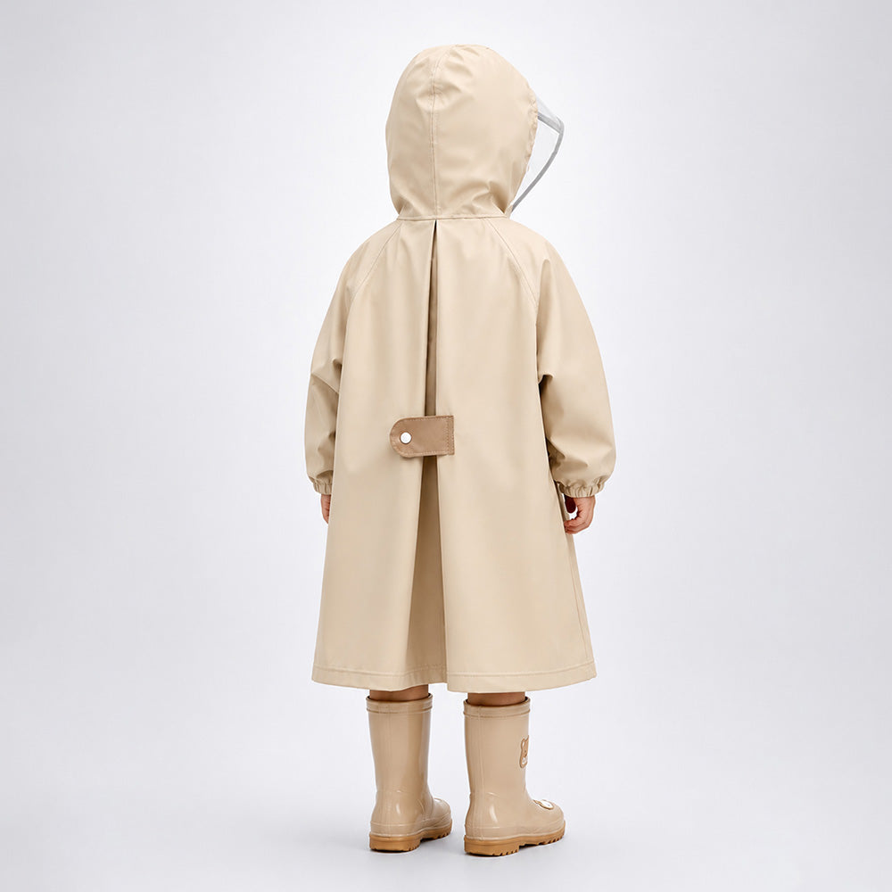 Child wearing a beige raincoat and boots on a white background