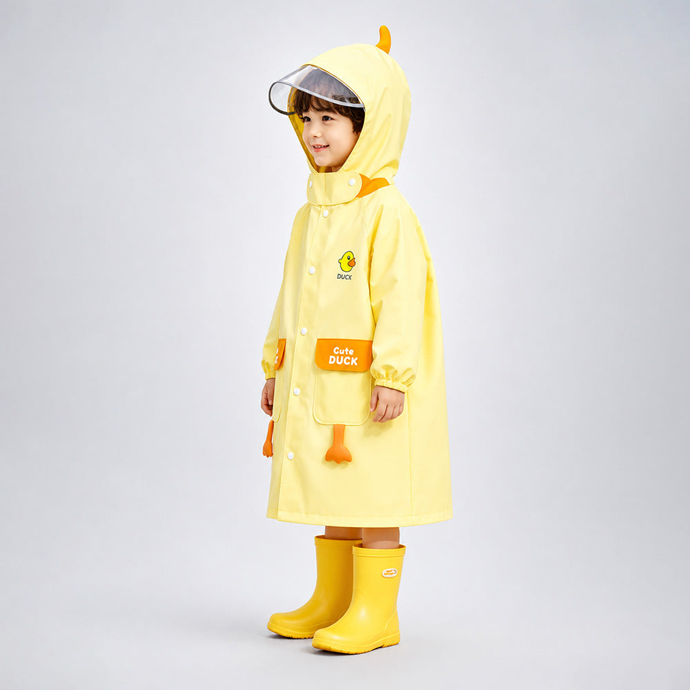 Child wearing a yellow duck-themed raincoat and boots on a gray background