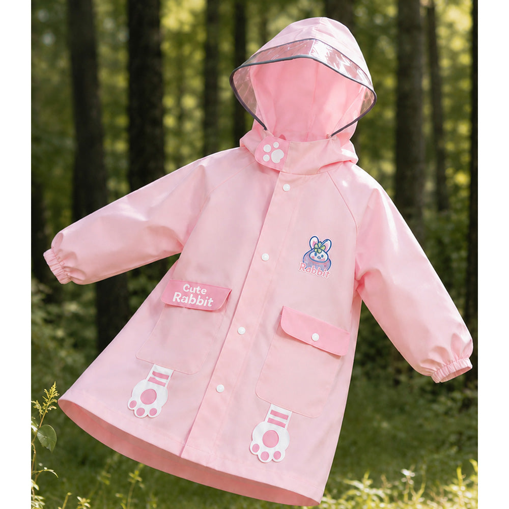 Pink children's raincoat with cartoon designs in a forest setting