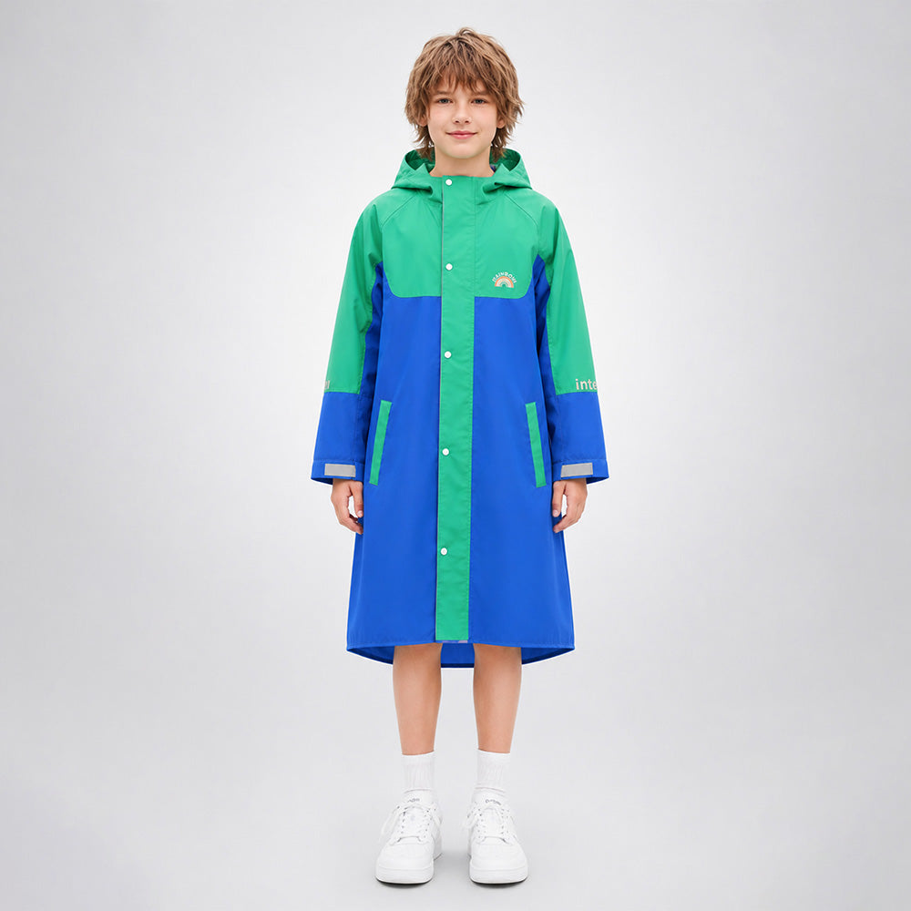 Child wearing a green and blue raincoat on a white background