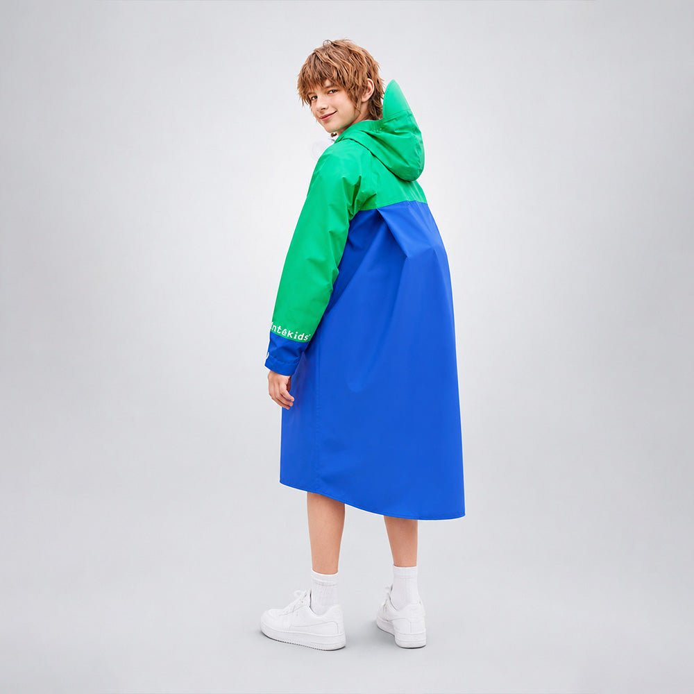 Person wearing a green and blue outfit on a plain background