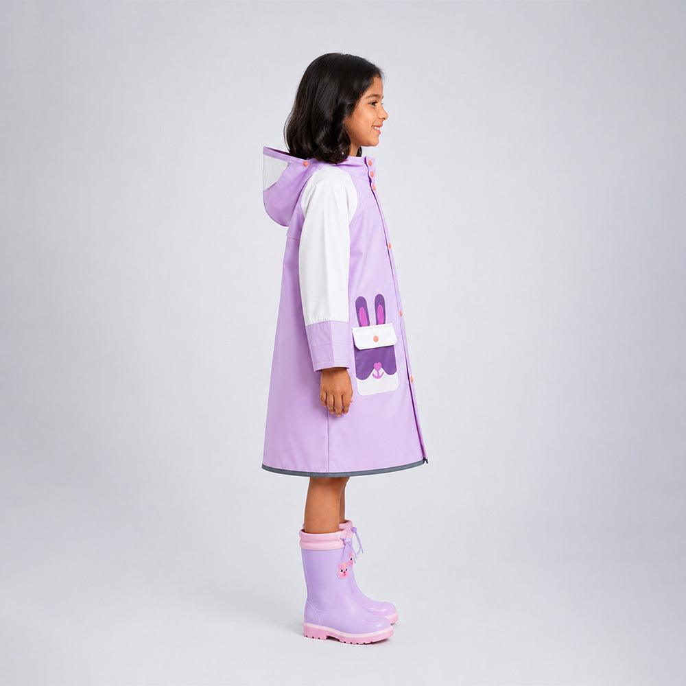 Child wearing a purple raincoat with a bunny design on a light gray background
