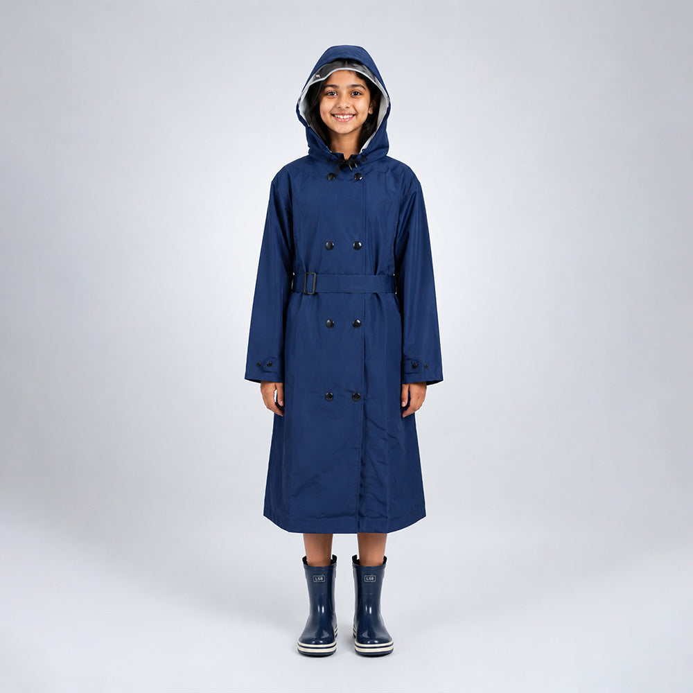 Person wearing a blue raincoat and matching rain boots on a white background