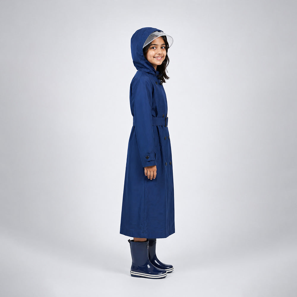 Person wearing a blue raincoat and boots on a white background