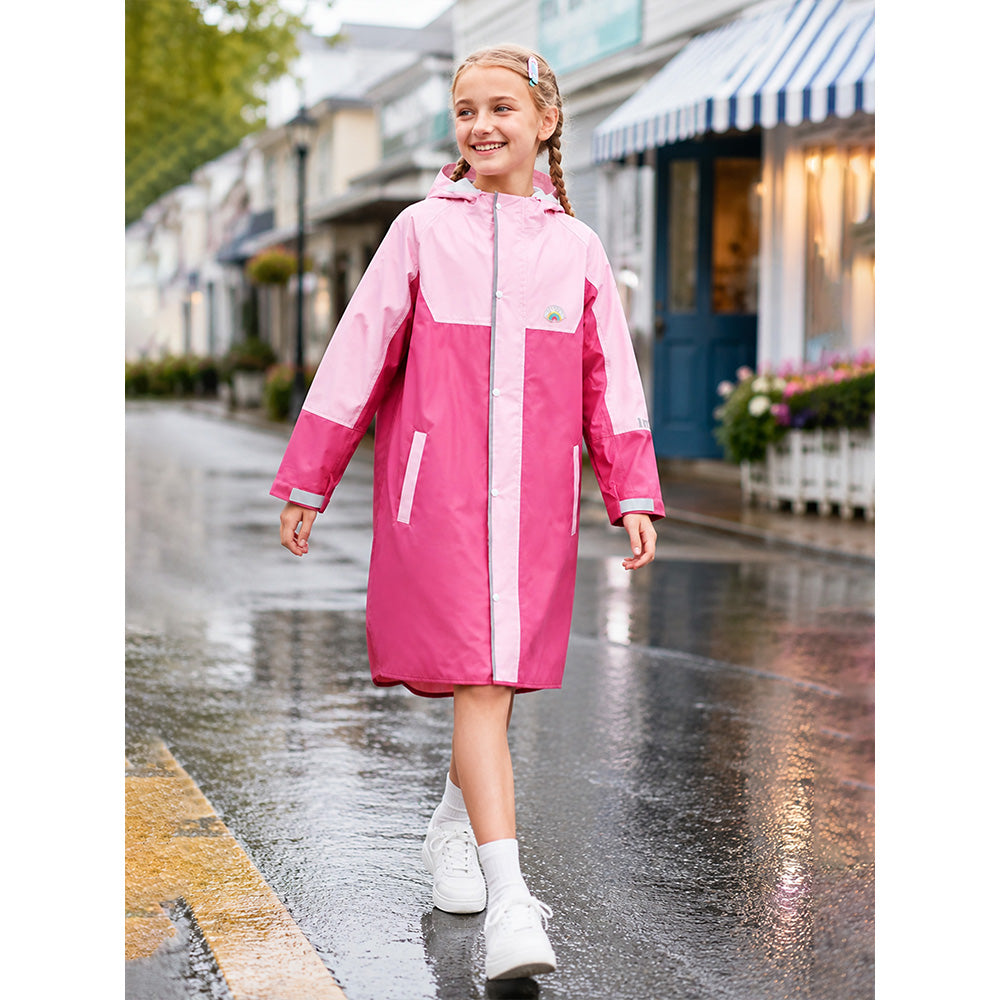 Girl in a pink raincoat walking on a wet street