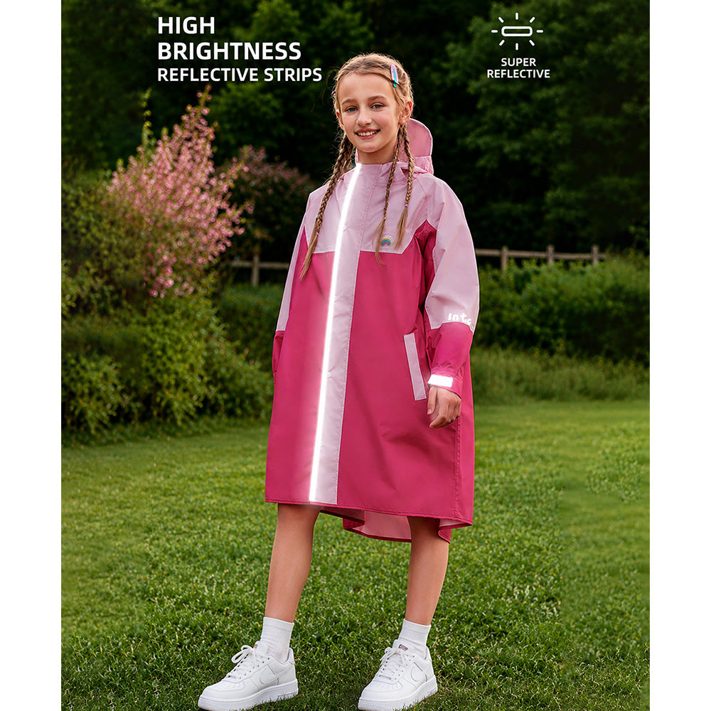 Girl wearing a pink and white raincoat with reflective strips outdoors.