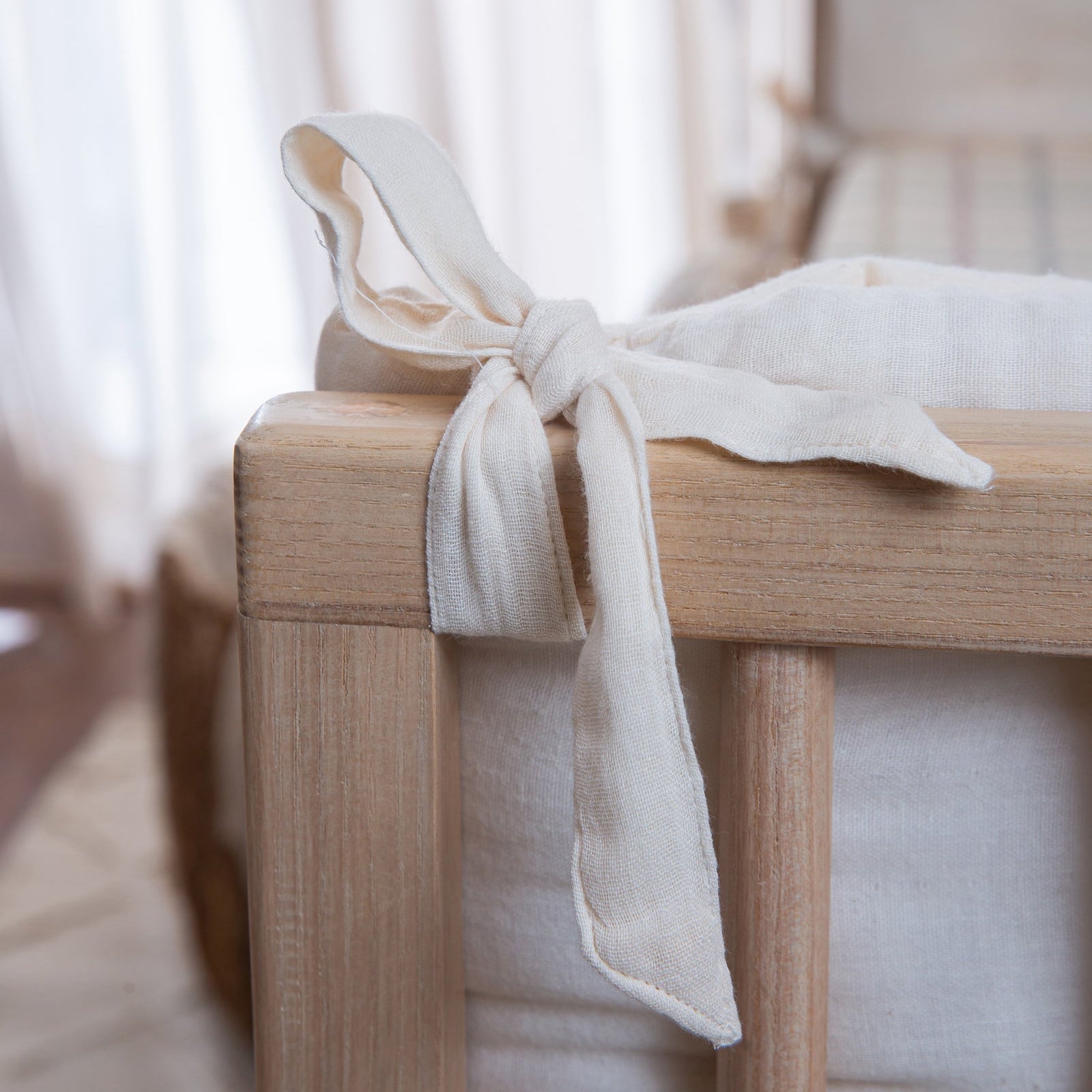 White ribbon tied on a wooden chair with a blurred background