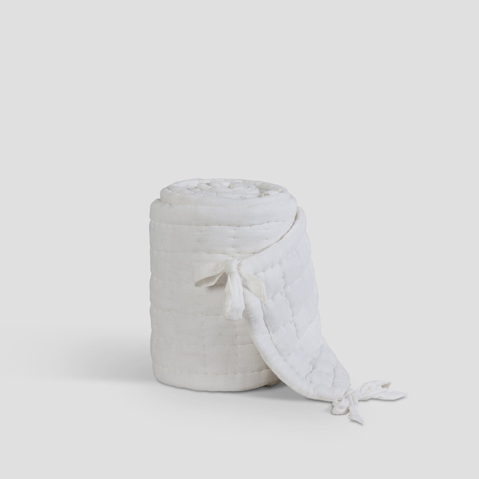 Textured woven basket with a white cover on a light gray background