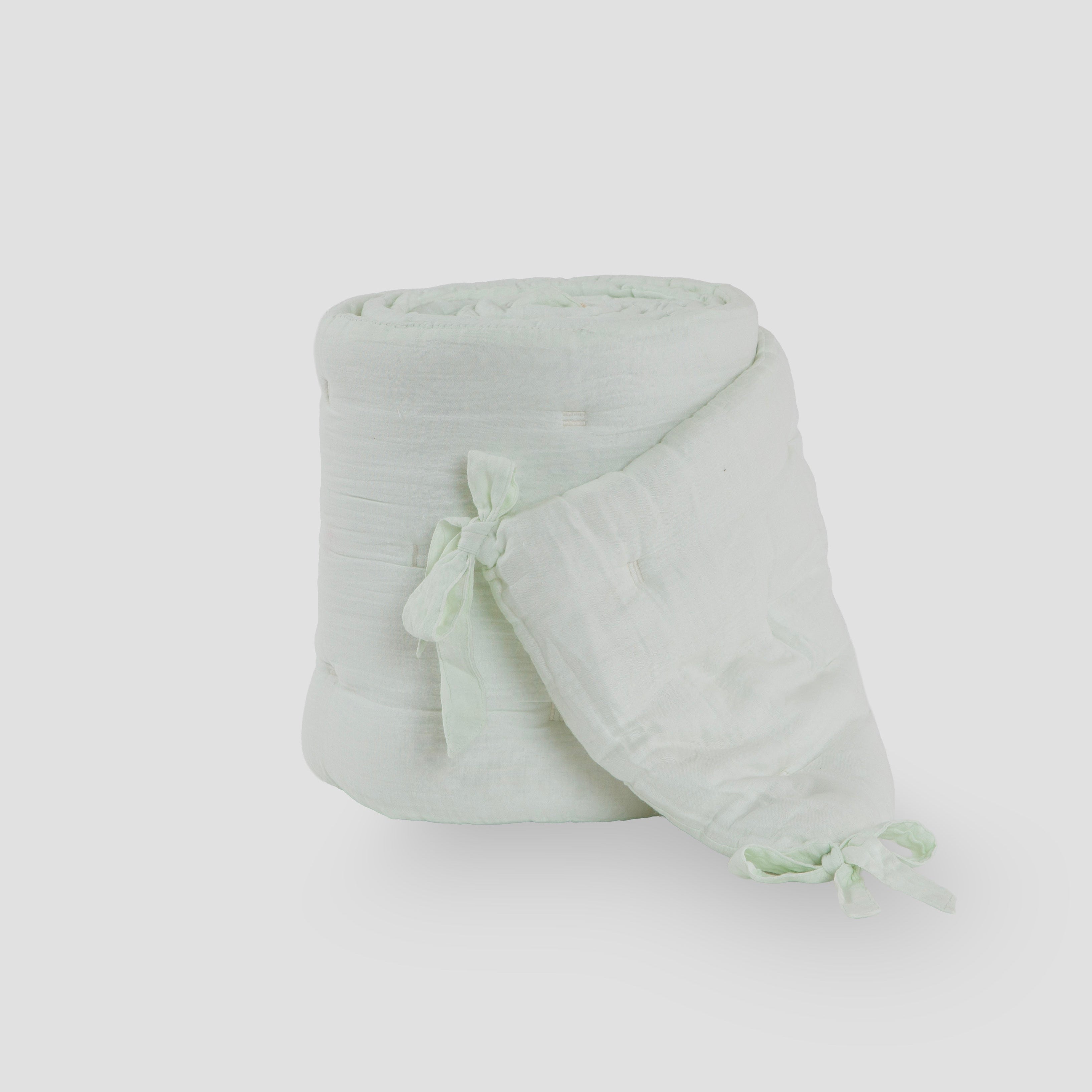 Light green hooded towel with a bow on a white background