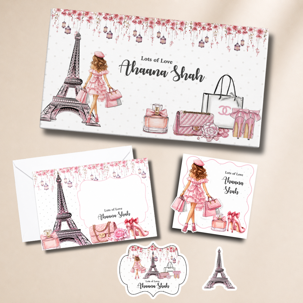 Personalized stationery set with Eiffel Tower, shopping bags, and perfume bottles on a beige background.