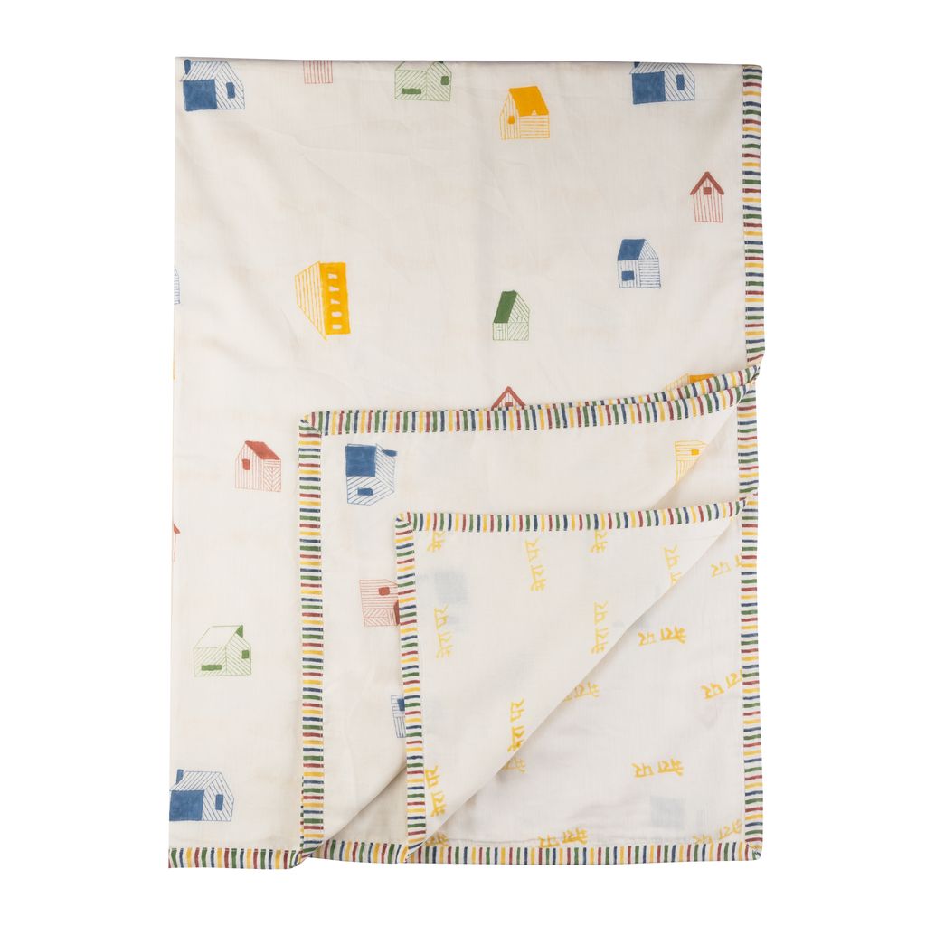 Folded fabric with colorful house pattern on a white background