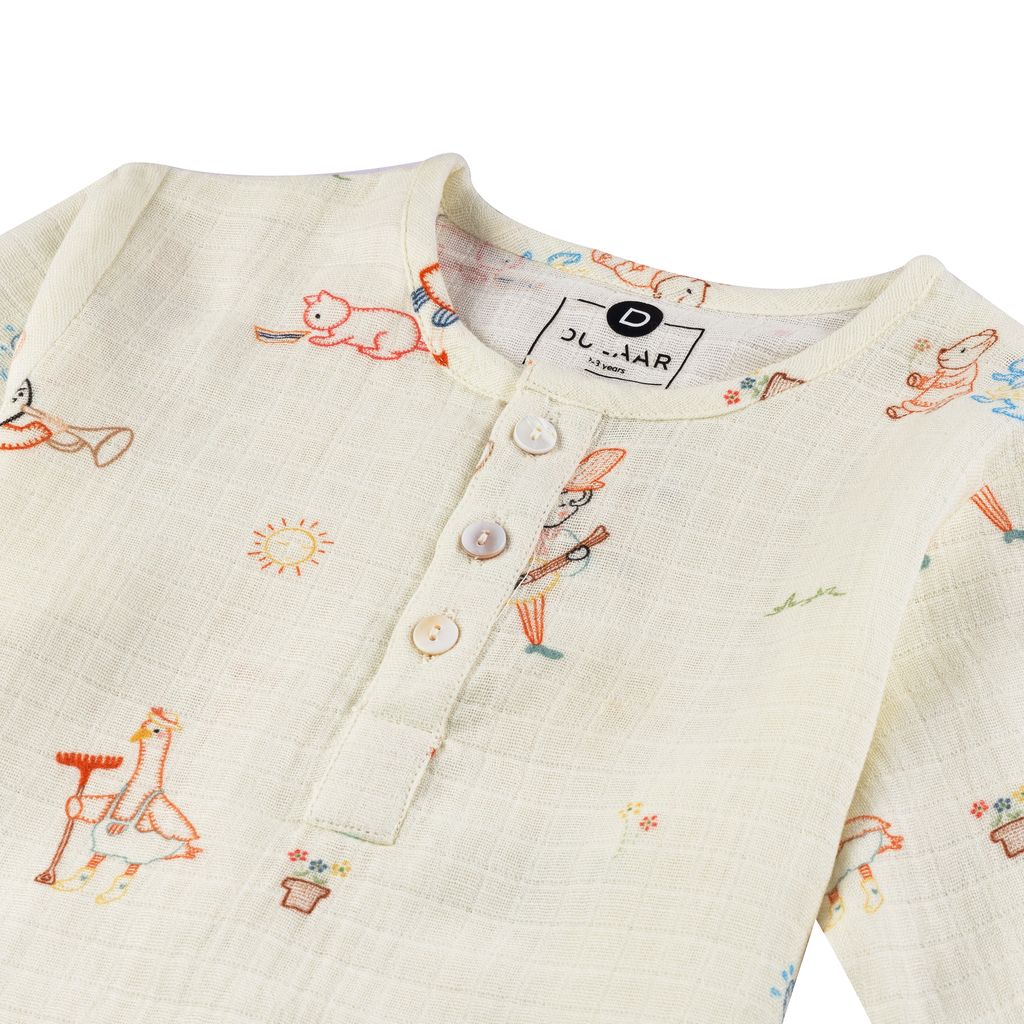 Children's outfit with embroidered designs on a white background