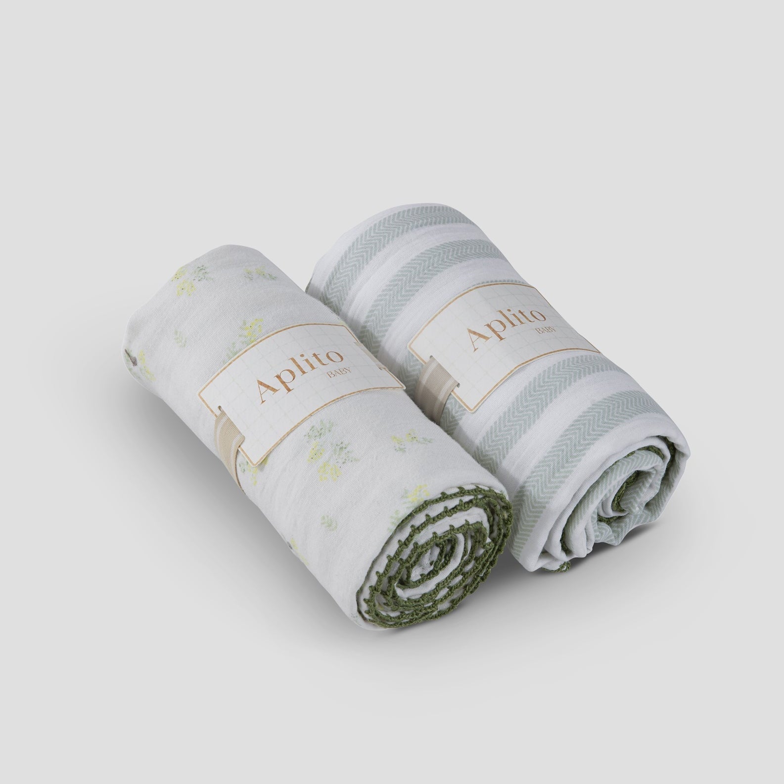 Two rolled-up towels with 'Aphrodite' branding on a light gray background