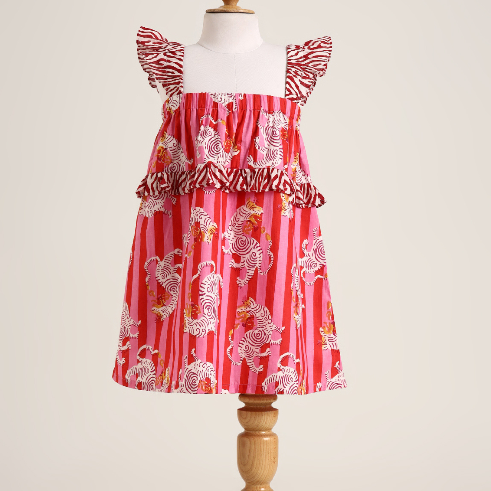 Printed cotton sleeveless dress. Detailed with frils on shoulder and waist