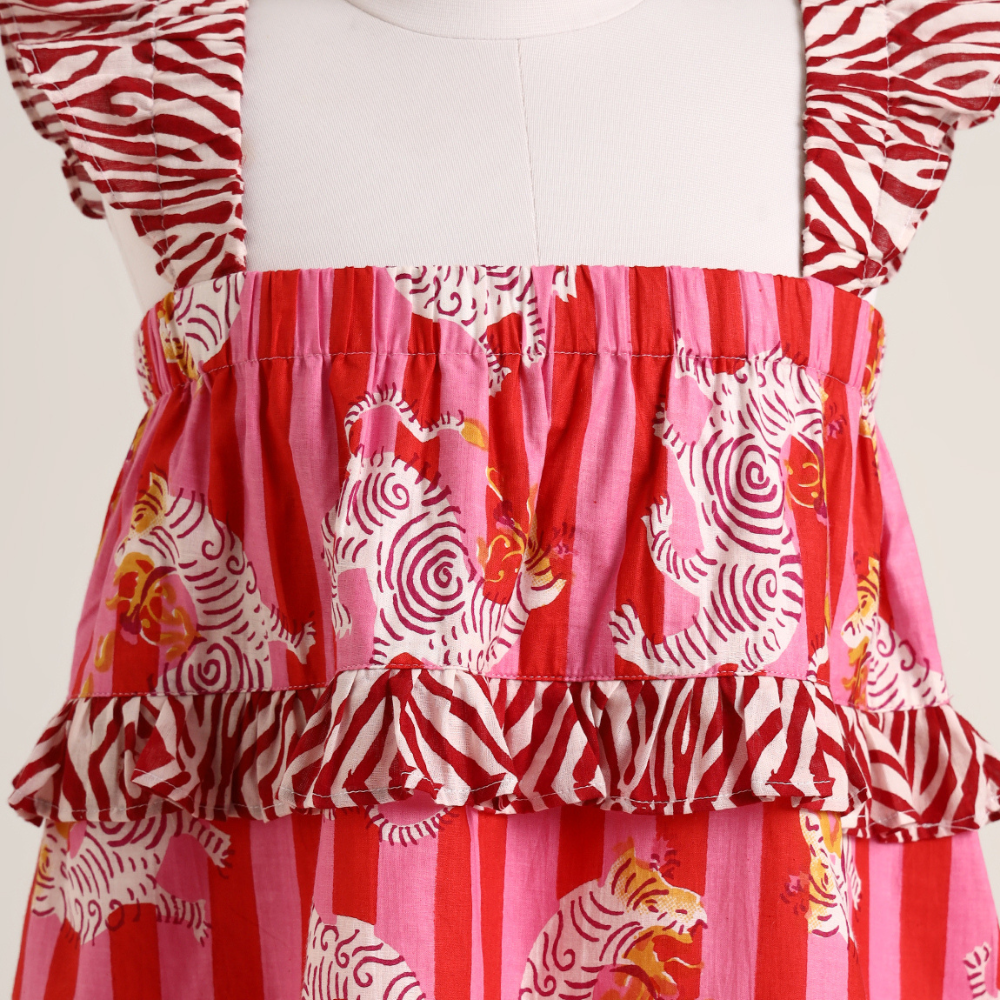 Printed cotton sleeveless dress. Detailed with frils on shoulder and waist