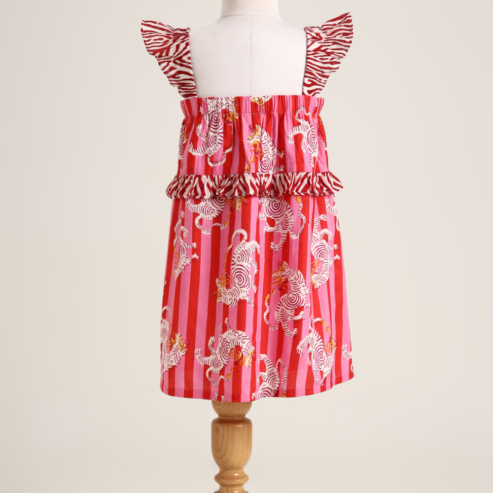 Printed cotton sleeveless dress. Detailed with frils on shoulder and waist