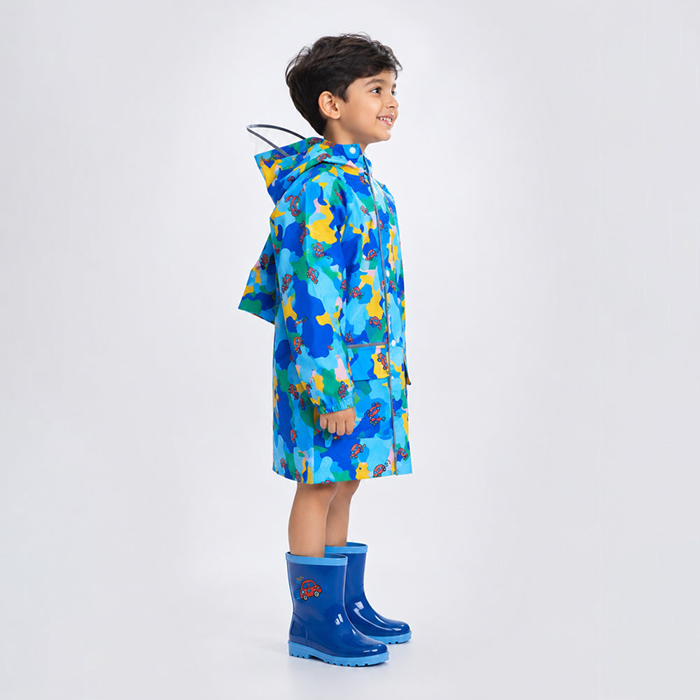 Side view of child wearing blue color pop knee-length raincoat with hood, clear brim and blue rain boots