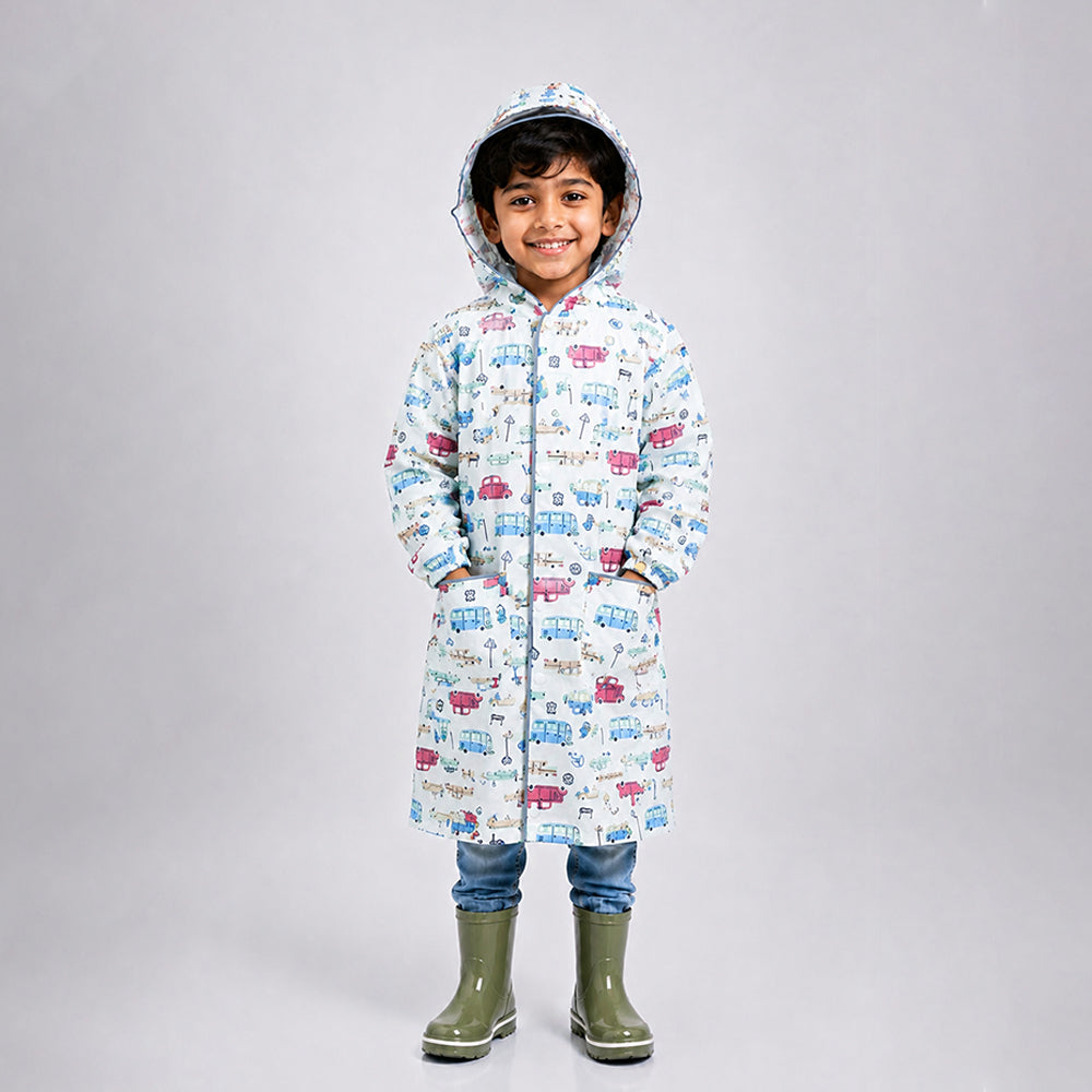 Child wearing cream vintage car print knee-length raincoat with hood and green rain boots