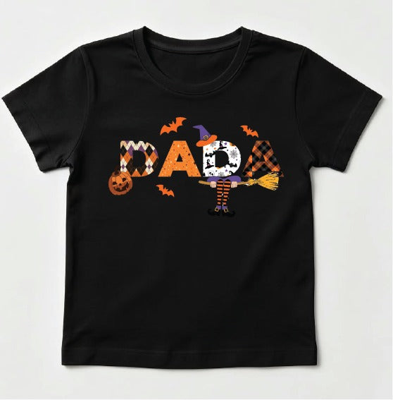 A black short-sleeve kids' t-shirt featuring a 'DAD' graphic filled with Halloween-themed patterns (chevron, distressed, plaid, and stripes) with a witch hat, broomstick, and bats.