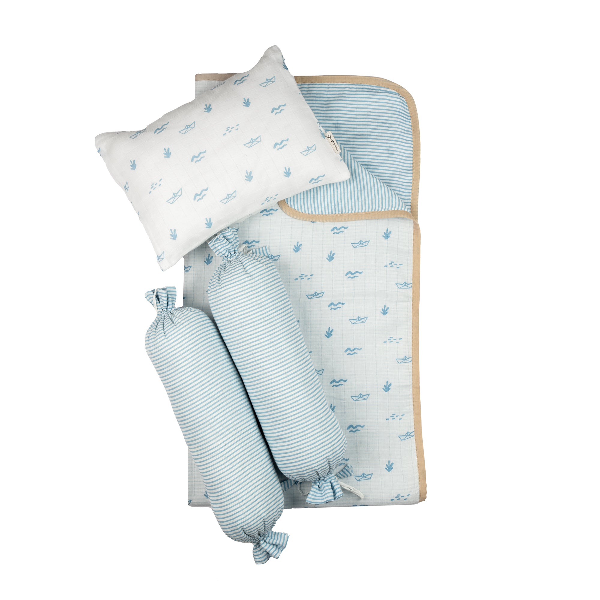 Boat print baby bedding flatlay with pillow, blanket and two bolsters