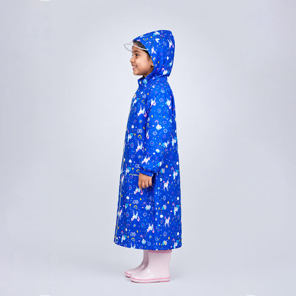 Side view of child wearing navy unicorn print knee-length raincoat with hood and transparent brim