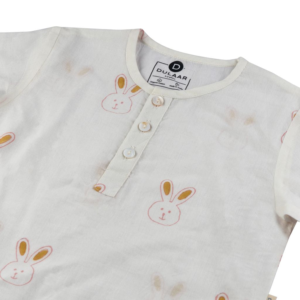 Children's shirt with bunny patterns and Dukaar branding on a white background