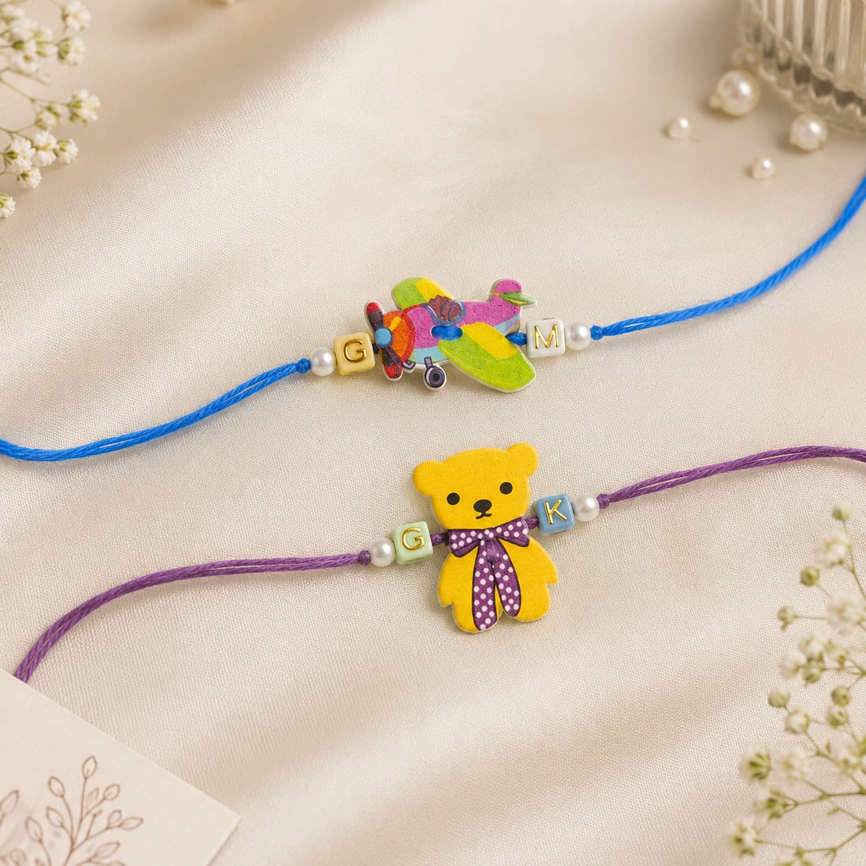Personalized initial wooden rakhi for kids with colourful bear and airplane designs for Raksha Bandhan.