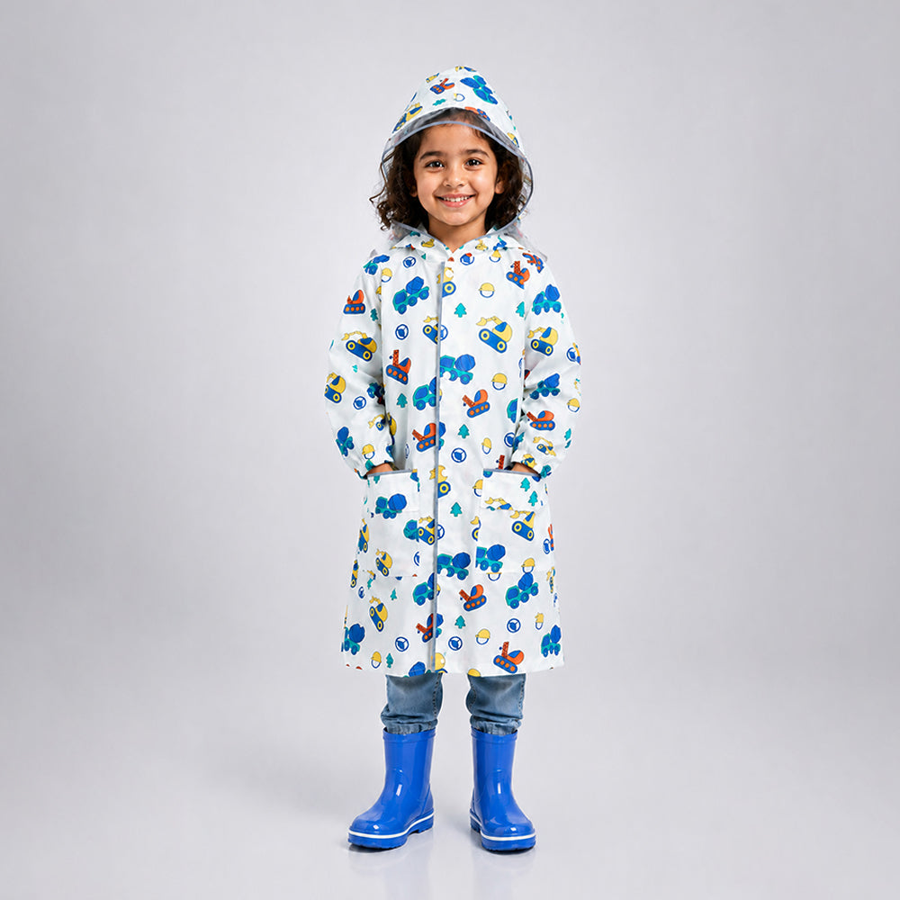 Child wearing white dumper truck print knee-length raincoat with hood and blue rain boots