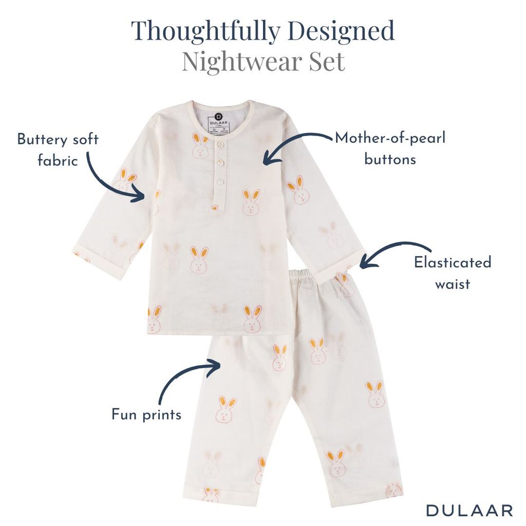 Children's nightwear set with bunny prints and text highlighting features, on a white background.