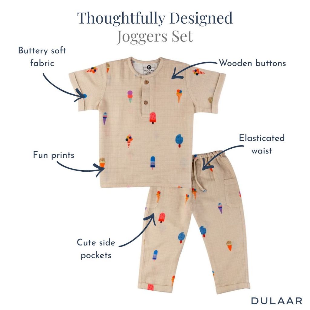 Children's jogger set with ice cream pattern and text highlighting features, on a white background.
